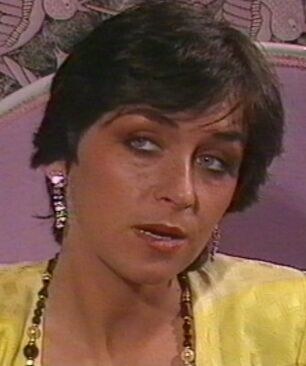 Cathy Ménard in a yellow patterned blouse in a 1980s film still